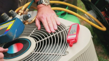 Technician testing Air Conditioning Unit